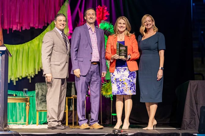 Kelly Beaver and Shaun Hart accept Business Excellence Award